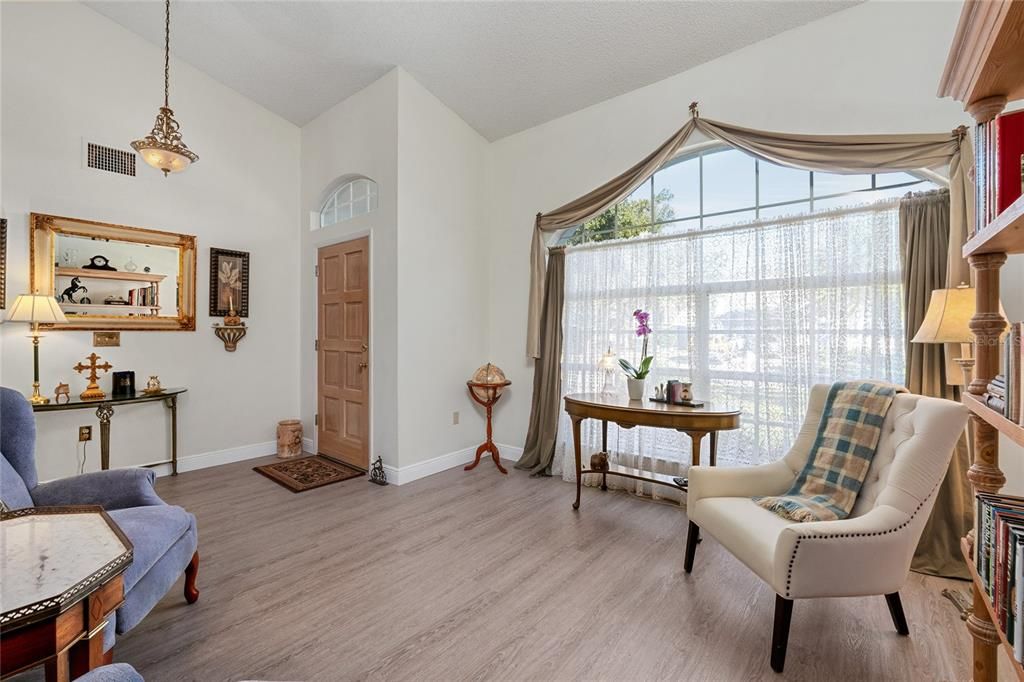 Entryway of the home opens into this spacious, bright room with high ceilings.