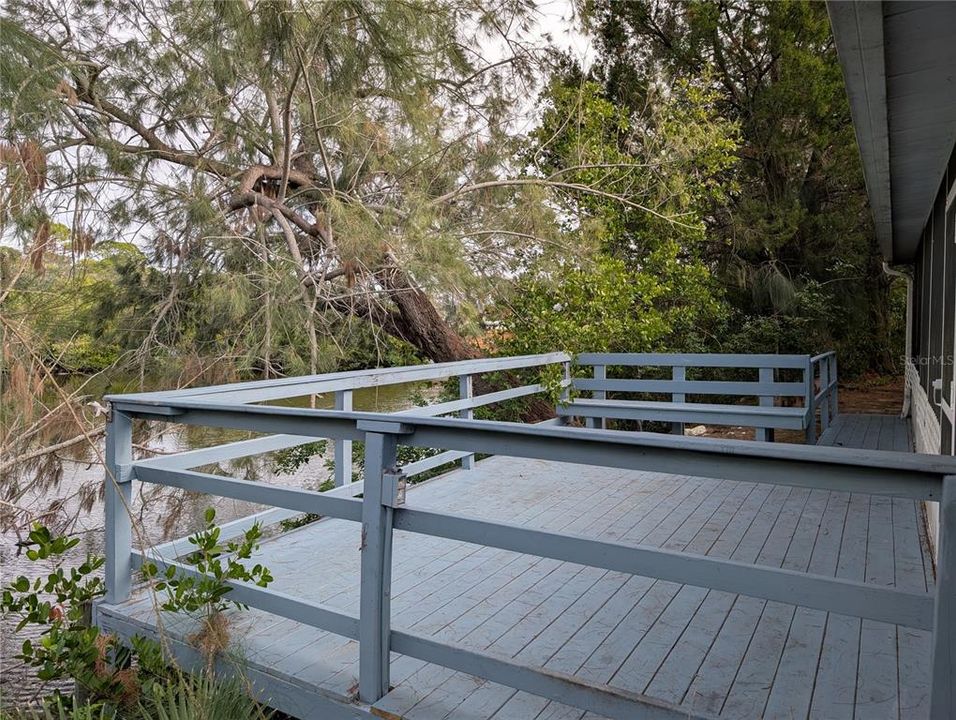 large deck with water views of the back