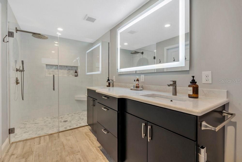 Primary Bathroom with all the bells and whistles! Double vanity, LARGE tiled walk-in shower, LED mirror with touch sensor, silent exhaust fan, and TOTO toilet with SMART Washlet bidet with motion sensor.