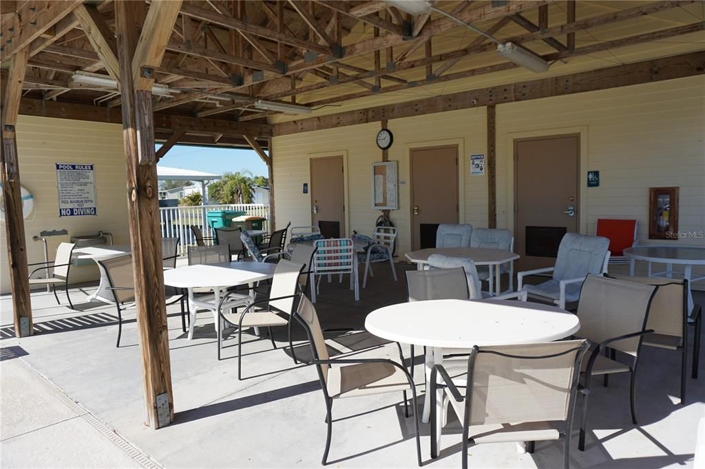 Covered patio and pool area with restrooms