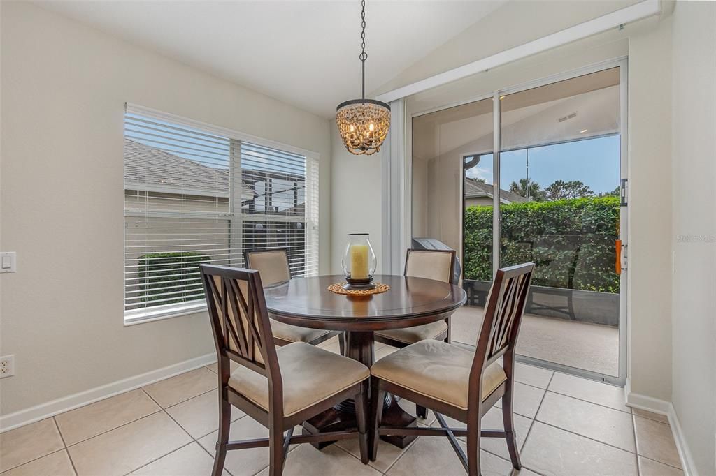 Separate breakfast dining area with decorative lighting and sliding patio door