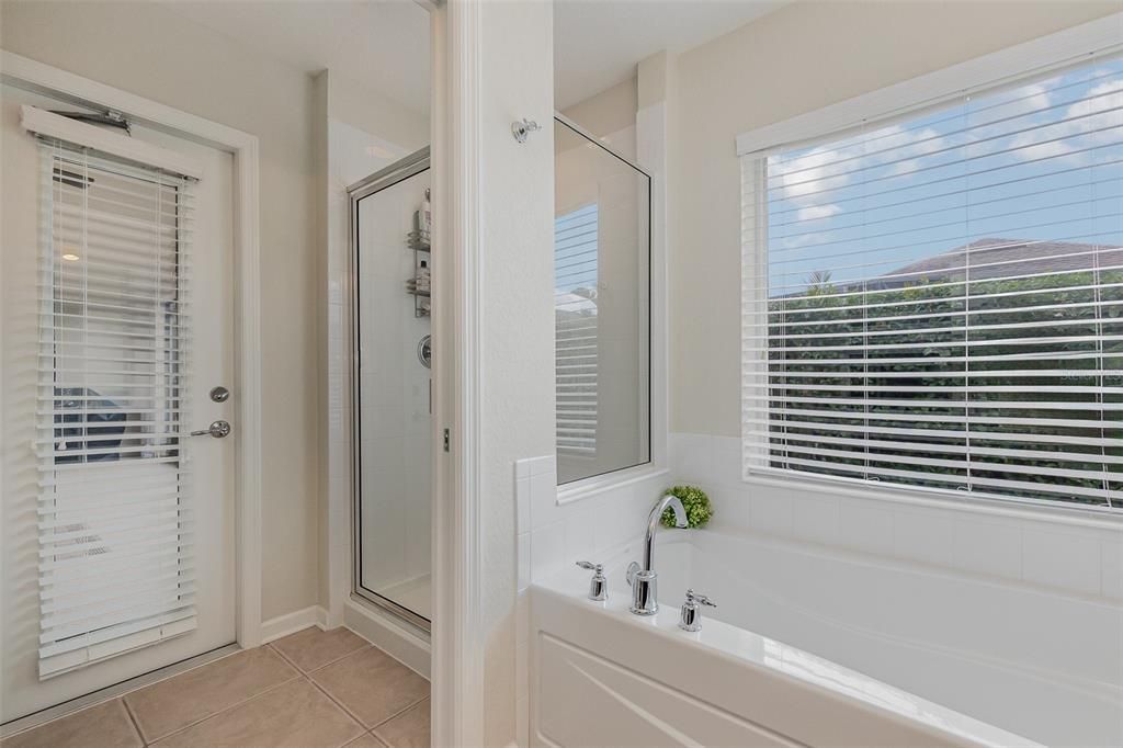 Tub and separate shower with direct access to lanai.