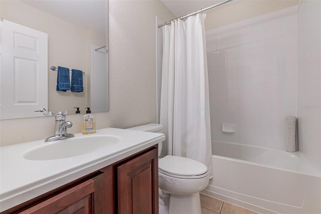 Private bath/shower combo with Corian countertops