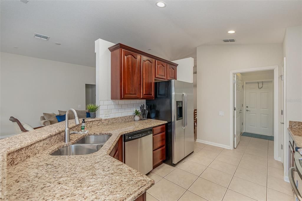 Granite countertops, subway backsplash and rich wood solid cabinets