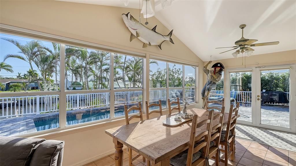 Dining area with water and pool view.