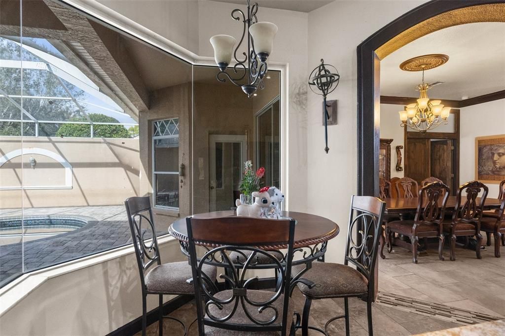 Breakfast nook with mitereed windows overlooking private courtyard pool.