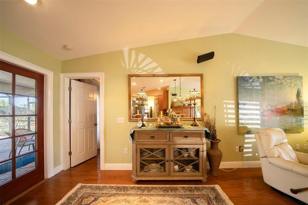 Living room with French doors to the lanai and door to the primary bedroom