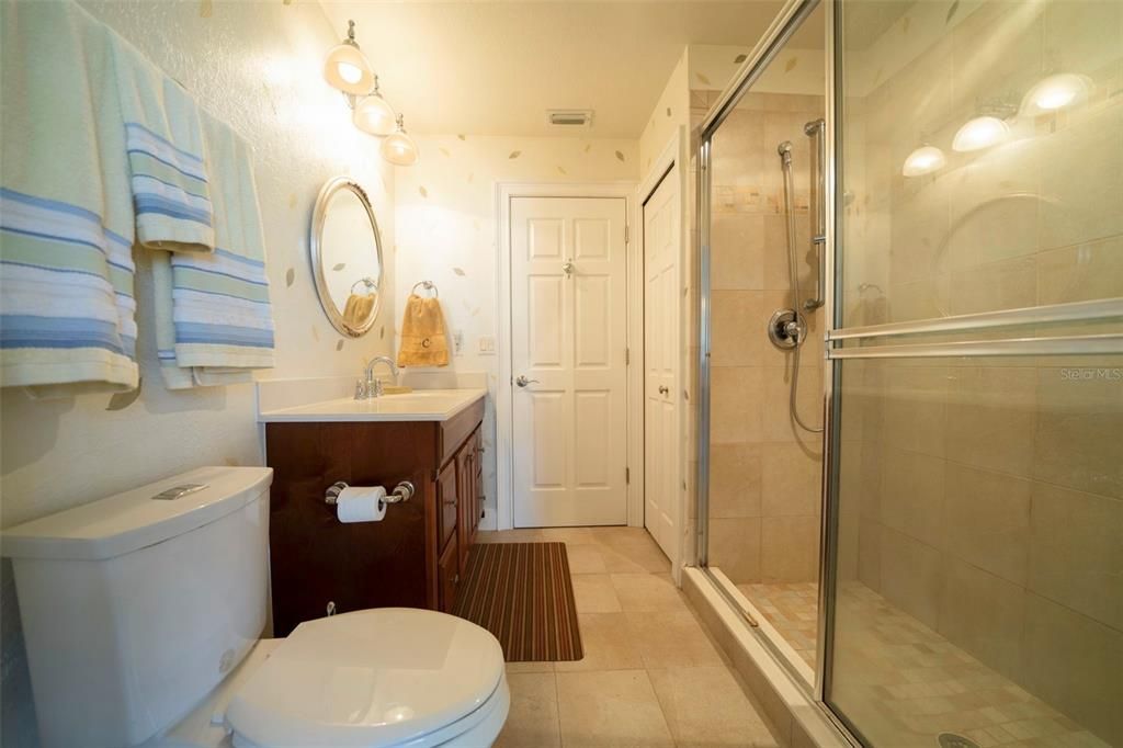 Guest bathroom with door to pool area.