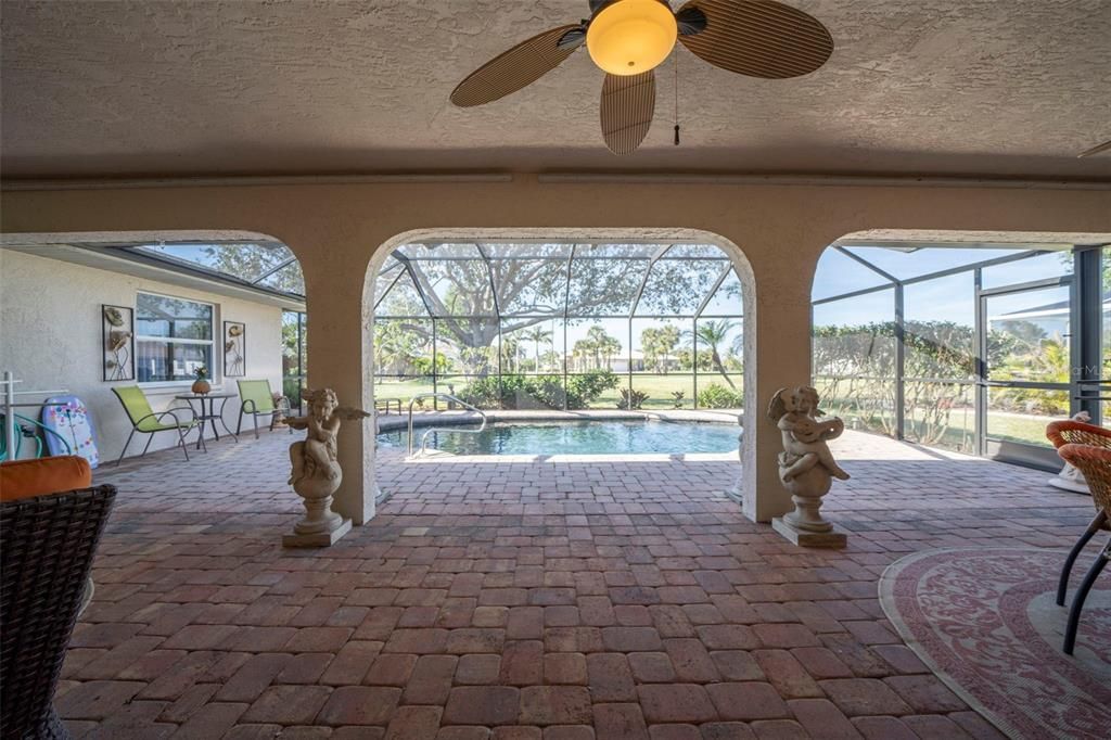 Pavered lanai with large area under roof.