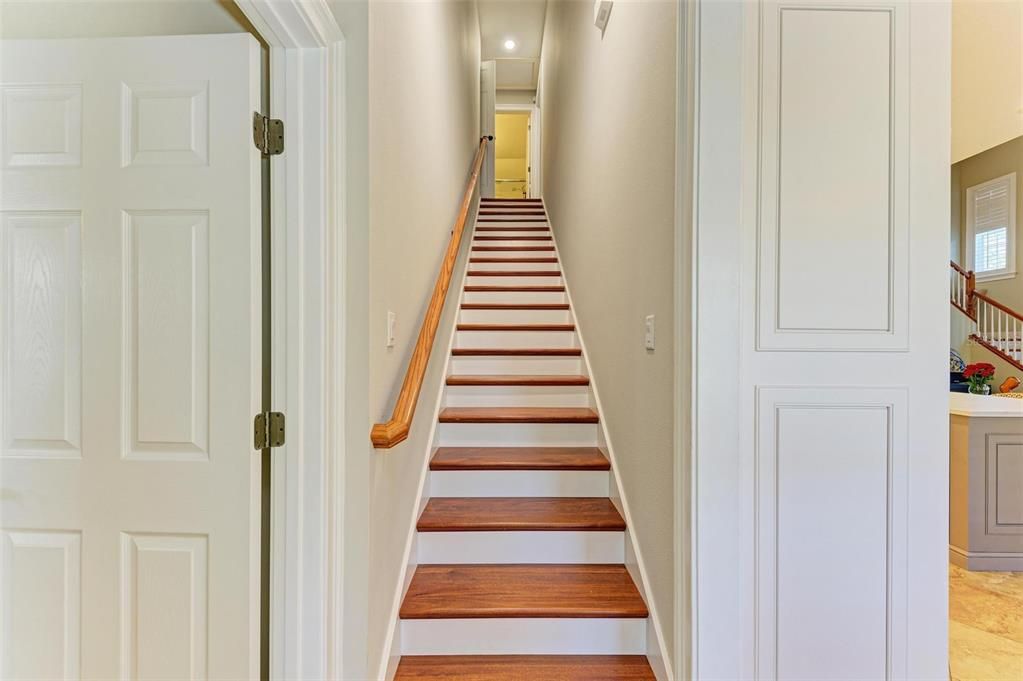 stairs near the half bathroom that leads to the bonus room, loft, one ensuite bedroom and two bedrooms and 2 more bathrooms