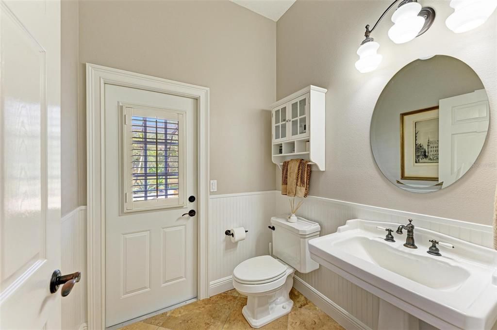 Half bathroom that leads to the pool patio