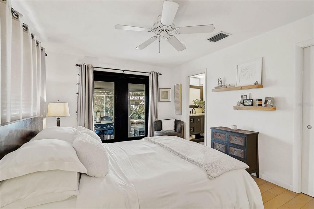 Primary Bedroom with French doors out to pool & lanai