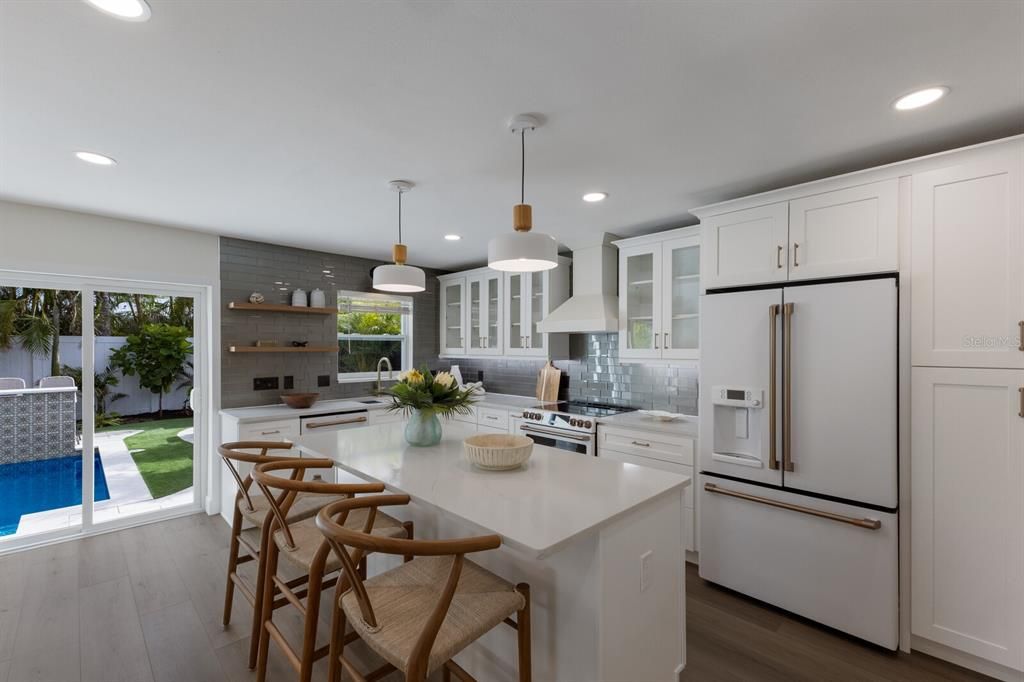 Designer kitchen w/ glassed cabinetry that are soft closed - drawers too