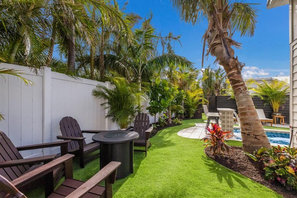 Professional turf and fire pit area in the backyard oasis