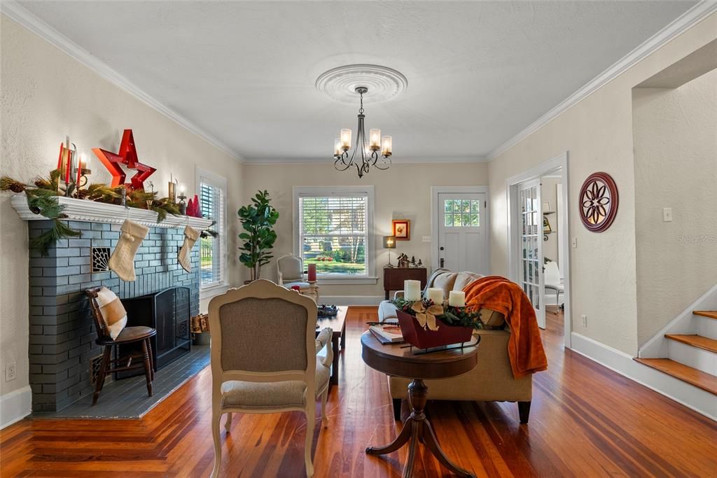 The French Doors on the right of the room just past the front door lead to a first-floor bedroom.  The room, currently being used as an office, has direct access to a full bathroom.  The bathroom can also be accessed from the hall on the other side of the staircase.