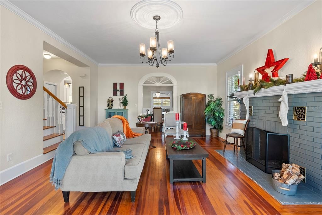 Discover the historic charm of this living room featuring original hardwood floors, French Doors, glass door knobs and the fireplace as the focal point.