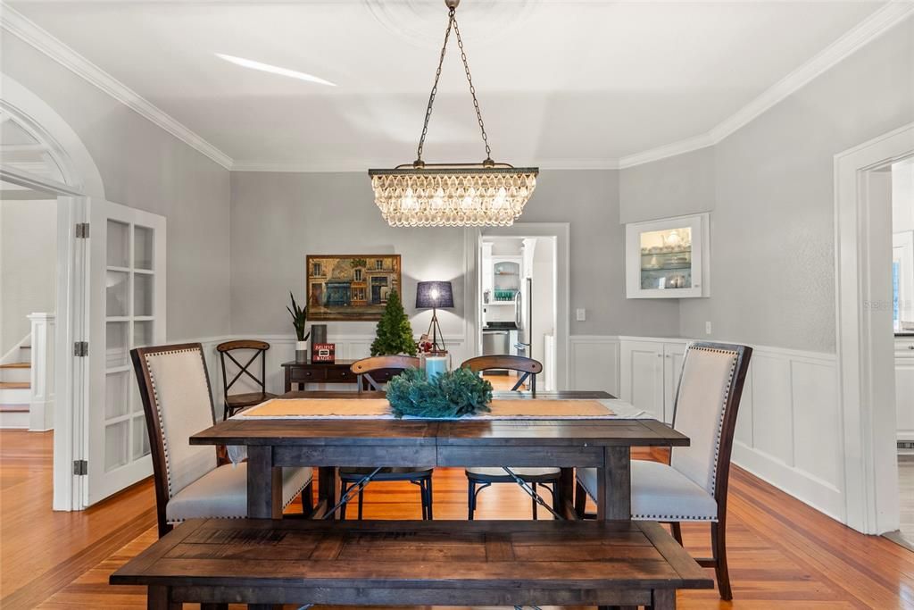 The formal dining room is flanked by the living room, family room and kitchen.  It boasts original hardwood floors, French doors and built-in cabinets.