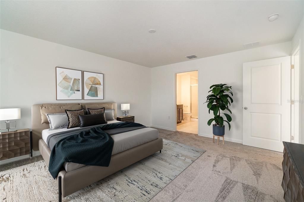 Primary bedroom with ample room for king bed and furniture.