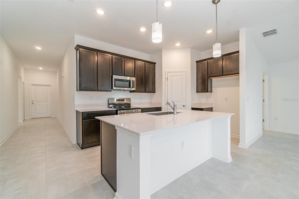 Kitchen with brand new appliances and quartz countertops.