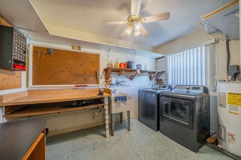 Laundry room with sink and work bench and ceiling fan