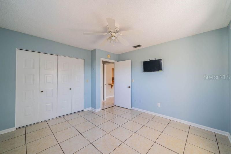 Guest bedroom with mounted TV