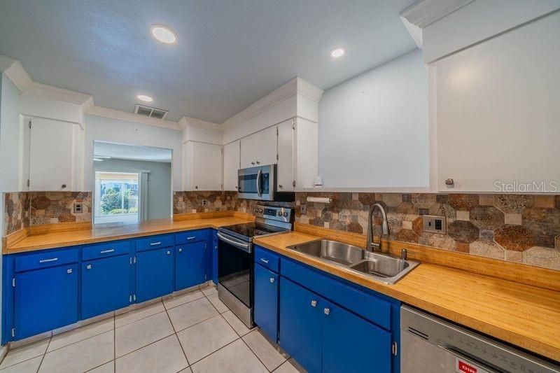 Kitchen has view of family room and lanai