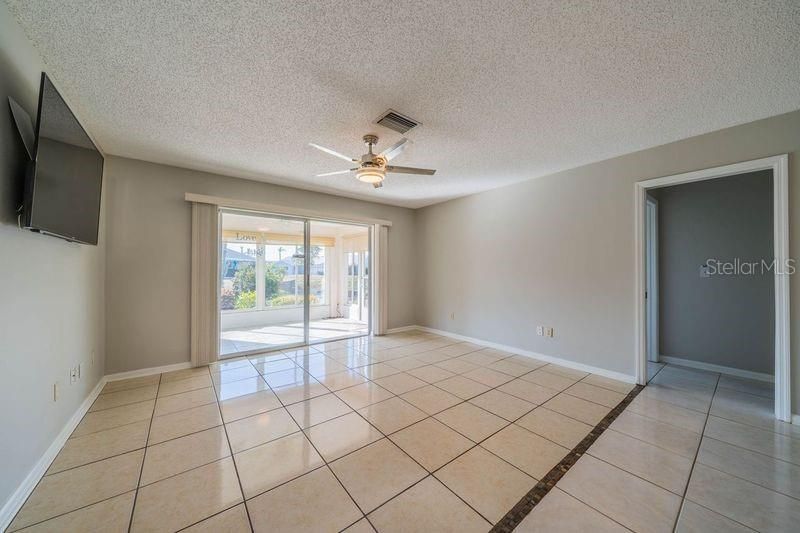 Family room including TV mounted and view of lanai