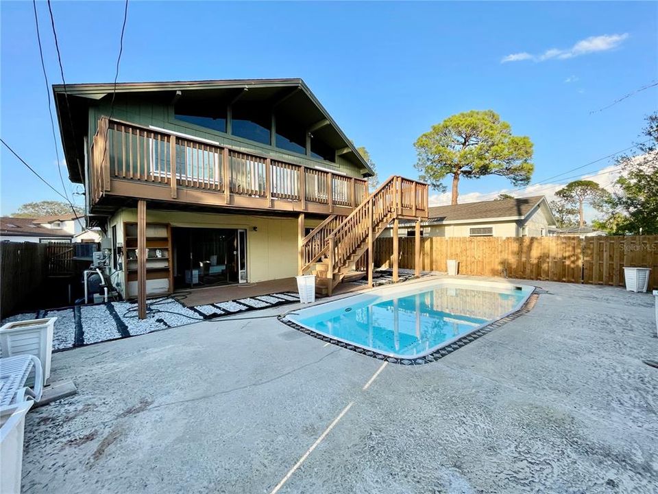 Backyard showing pool, shady deck below and Open deck above,