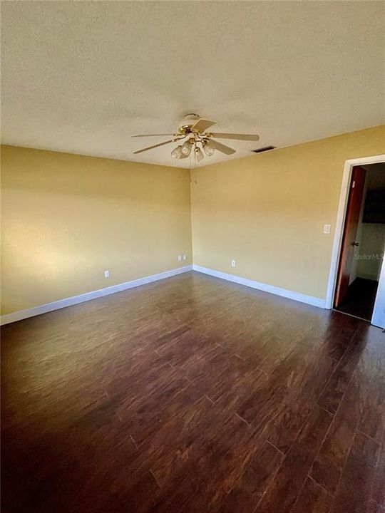 Primary bedroom has walk-in closet. Laminate flooring,