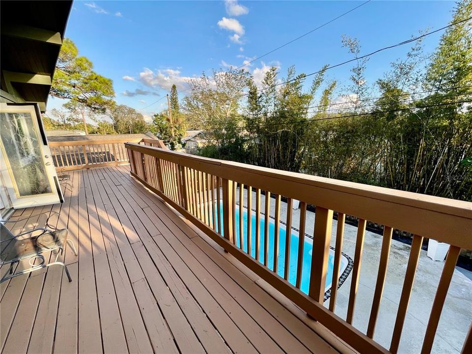 2nd floor deck showing French doors open on left lead to living area.