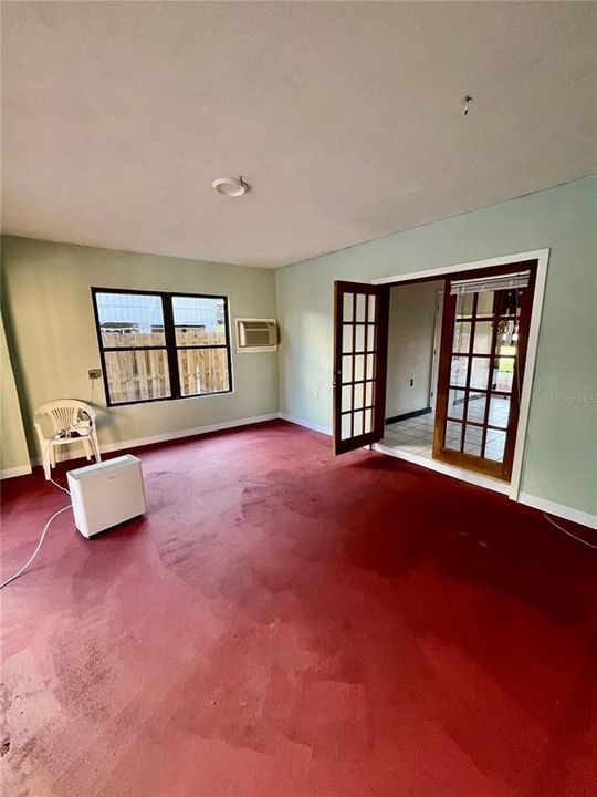 Bonus room adjacent to the front entry. Glass sliders to pool are out of sight on the left.