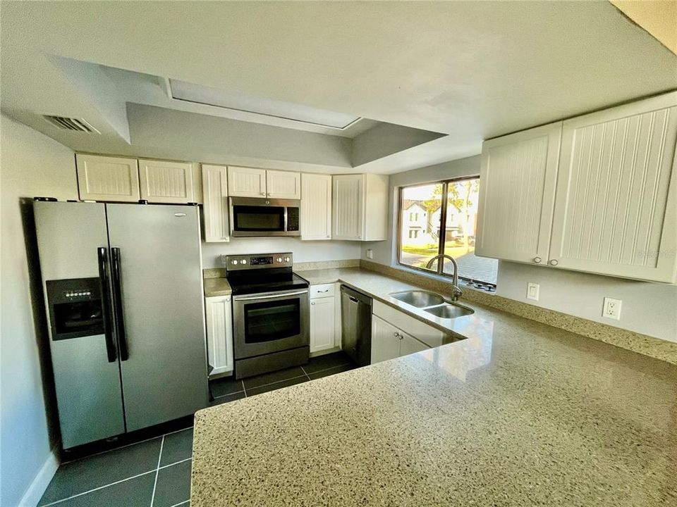 Plenty of cabinets in the bright kitchen w/window providing lots of natural light.