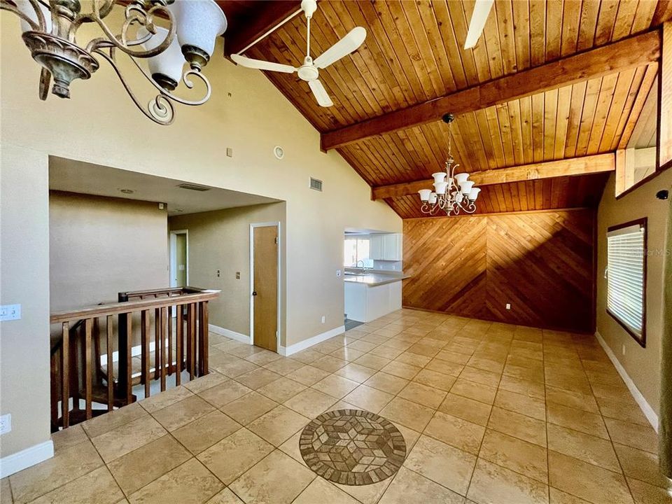 view of living/dining area.Railing on right is spiral staircase to downstairs entry.,