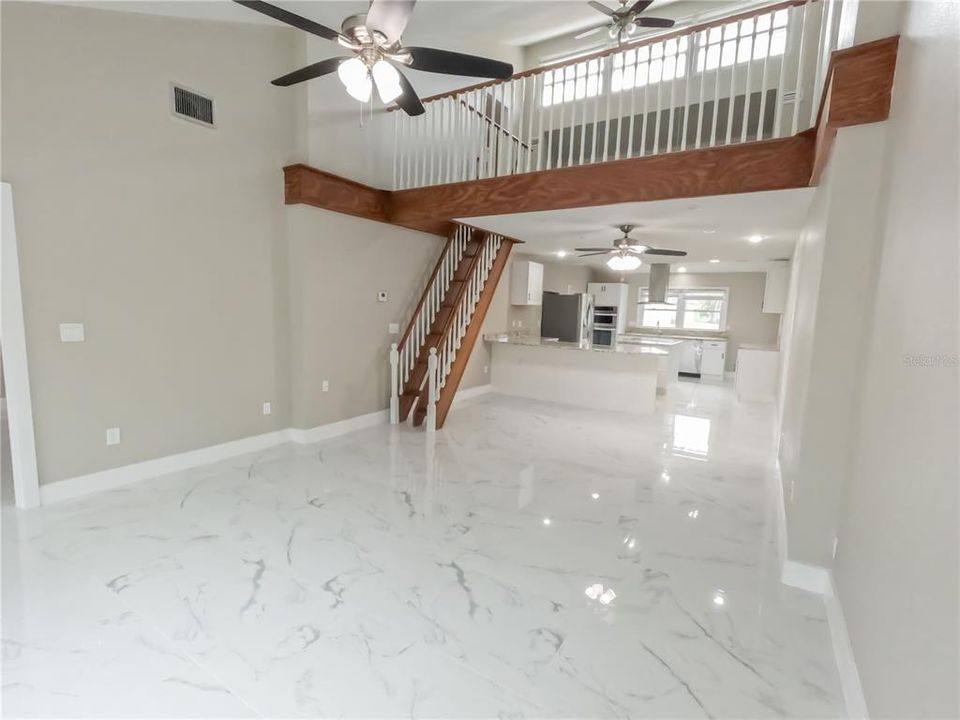 The kitchen opens to the large family room which leads to the lanai and pool