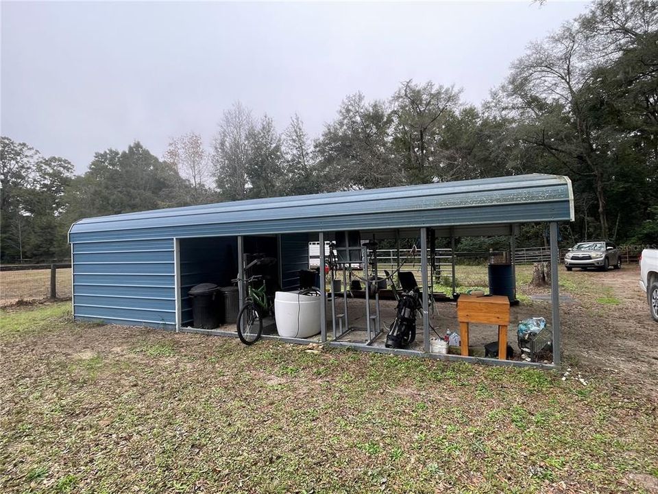 Carport has nice little feed storage room