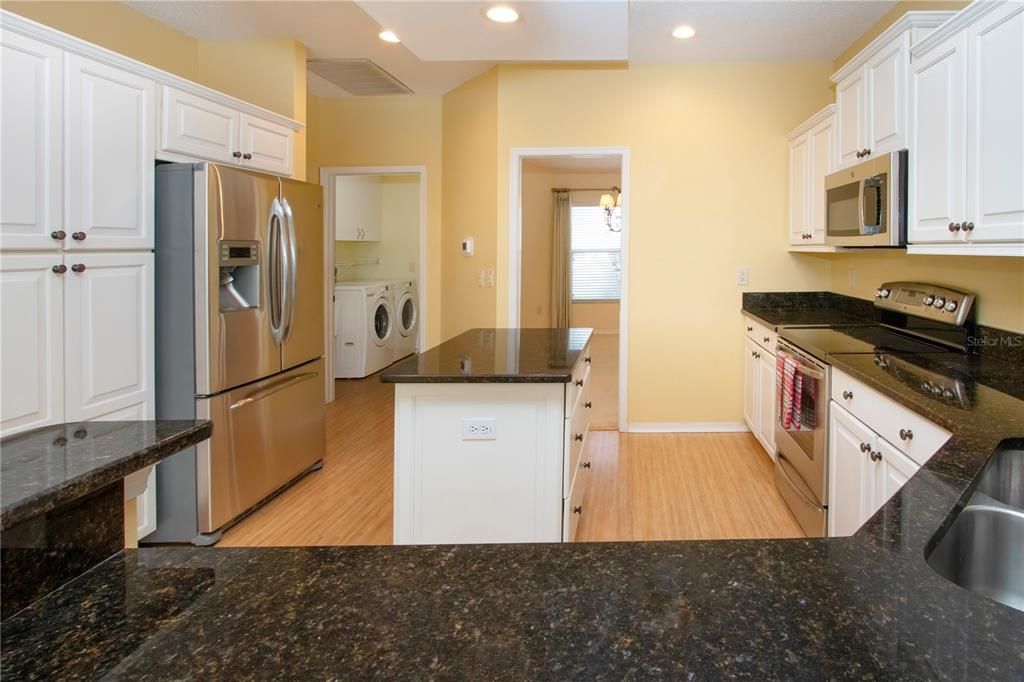 Remodeled Kitchen w/Granite counters, Roll-out drawers, Stainless appliances, Double undermount Sink & lots of Storage w/Upgraded cabinets