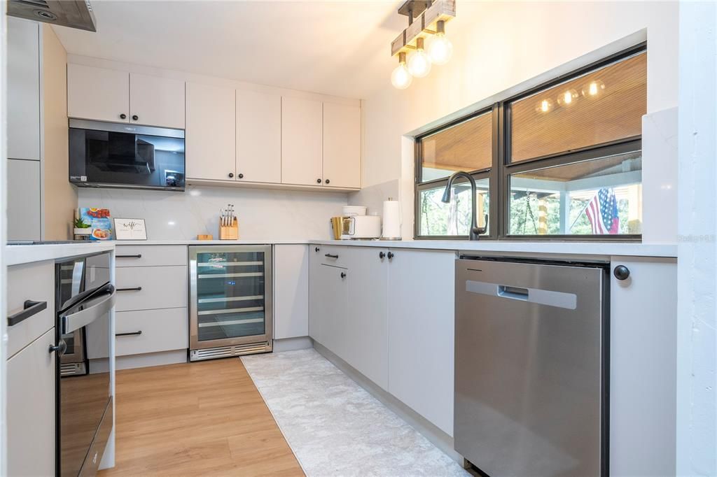 Kitchen with dishwasher, refrigerator, and wine cooler