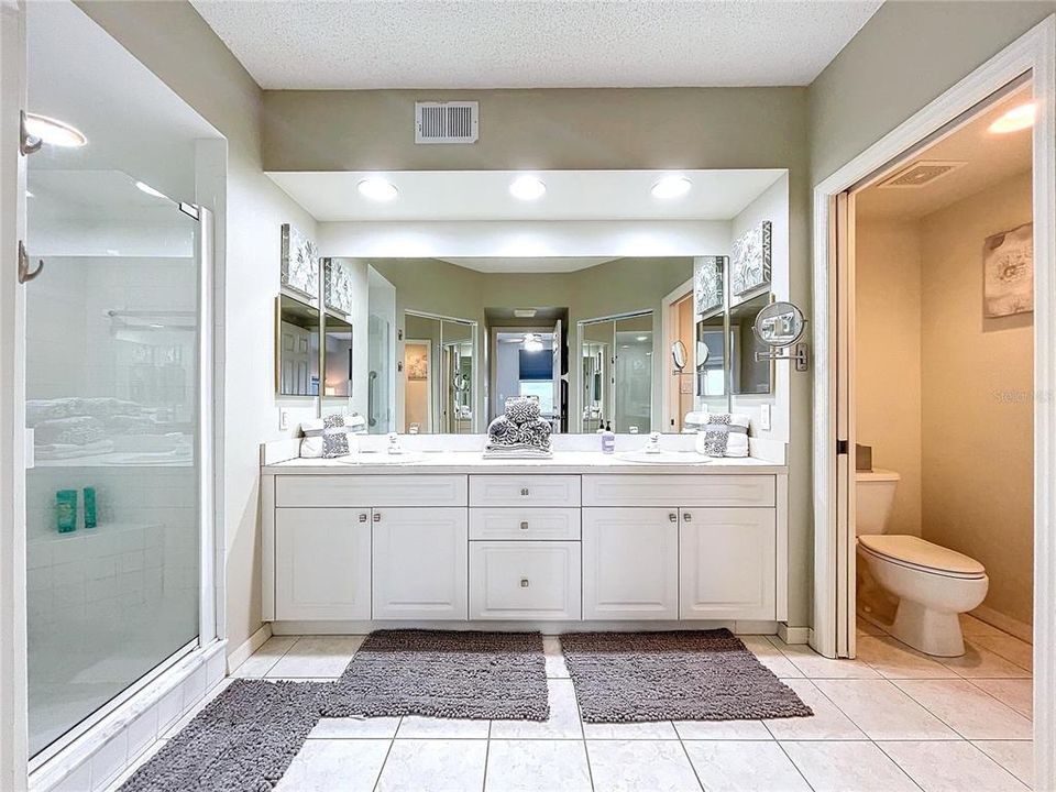 The Primary bathroom offers dual sinks, separate water closet, two walk-in closets and shower with glass door.