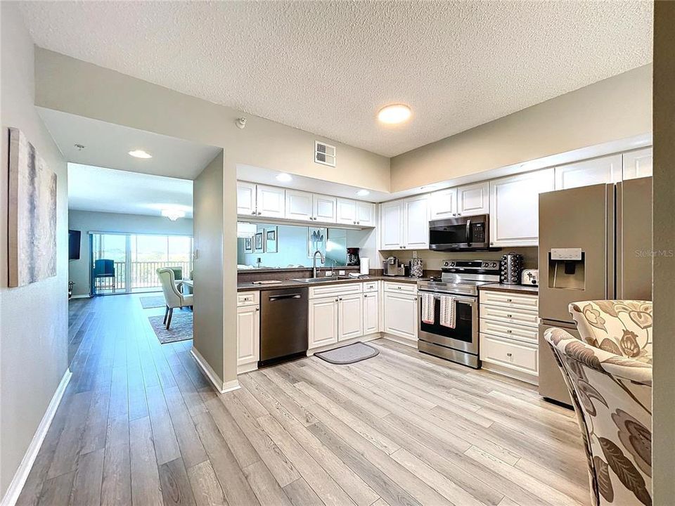 Enter in to this open floor plan condo with updated flooring and kitchen.