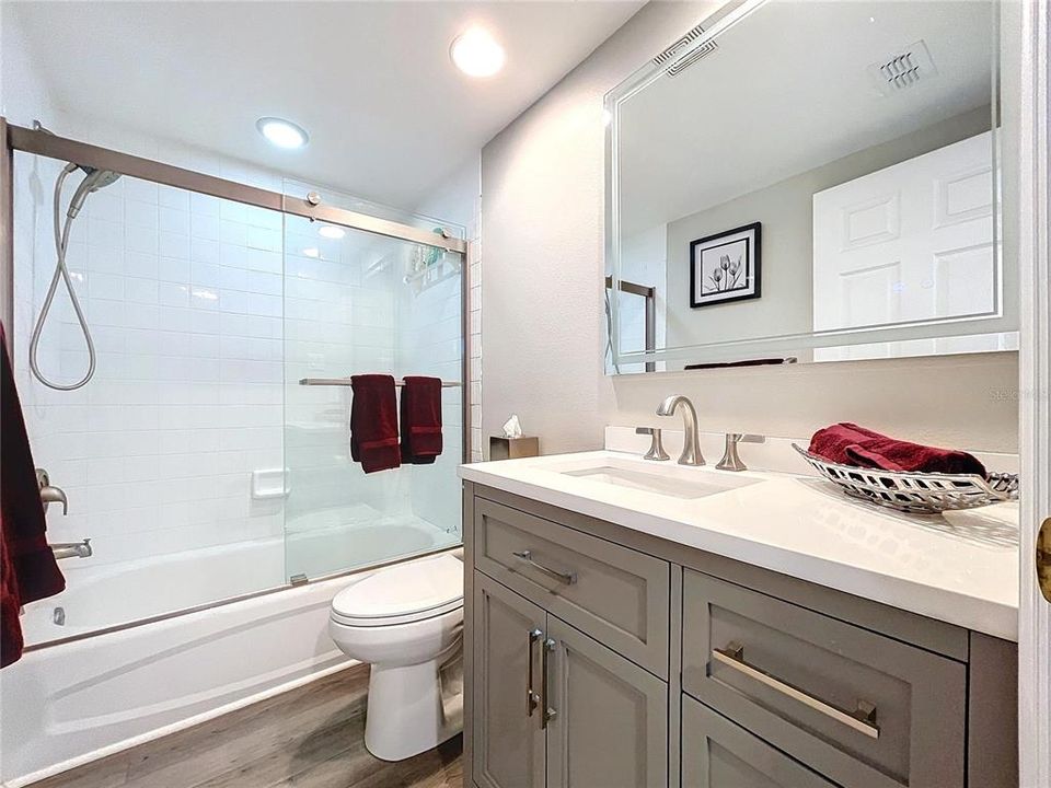 The guest bathroom is well equiped with shower/tub and sliding glass doors.