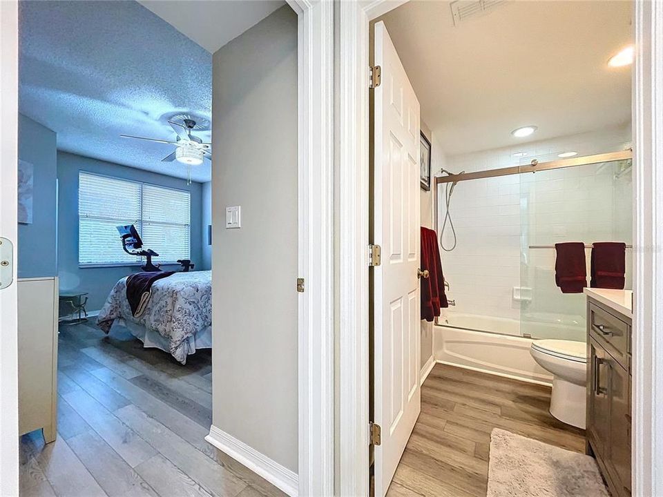 The guest bathroom is well equipped with shower/tub and sliding glass doors.