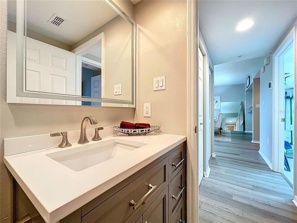 The guest bathroom is well equipped with shower/tub and sliding glass doors.