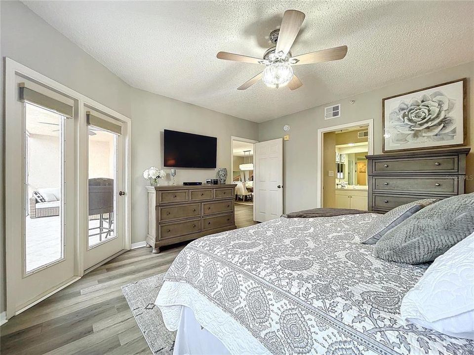 The Primary bedroom offers its own balcony access through French doors as well as plenty of natural lighting.