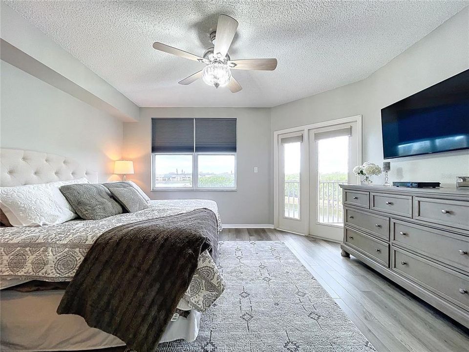 The Primary bedroom offers its own balcony access through French doors as well as plenty of natural lighting.