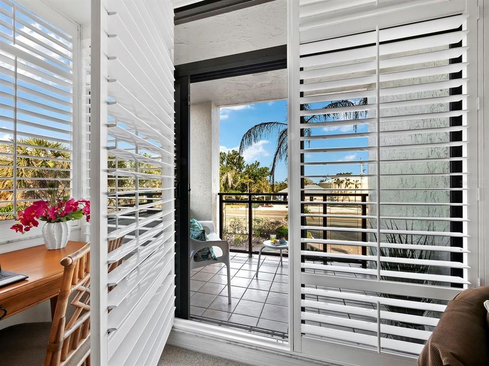 Behind the plantation shutters and sliding glass door lies your private balcony.