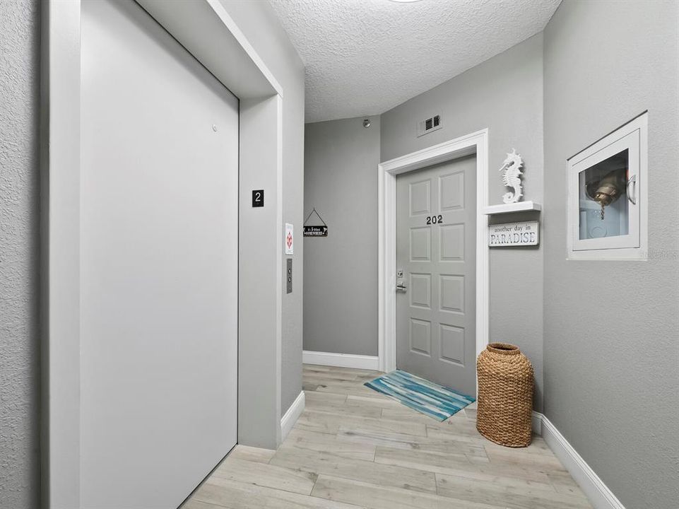 Take the elevator or stairs to the second floor where you'll find entry to your home. This landing is shared with only one other residence.