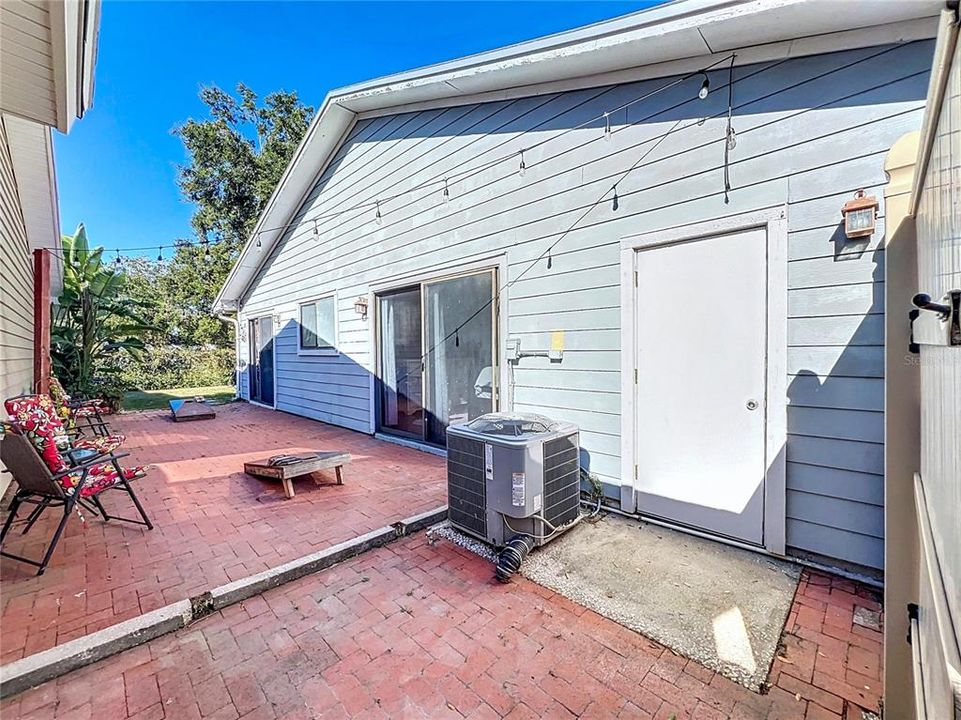 Side Patio Access from Primary Bedroom, Bedroom 1, and Garage