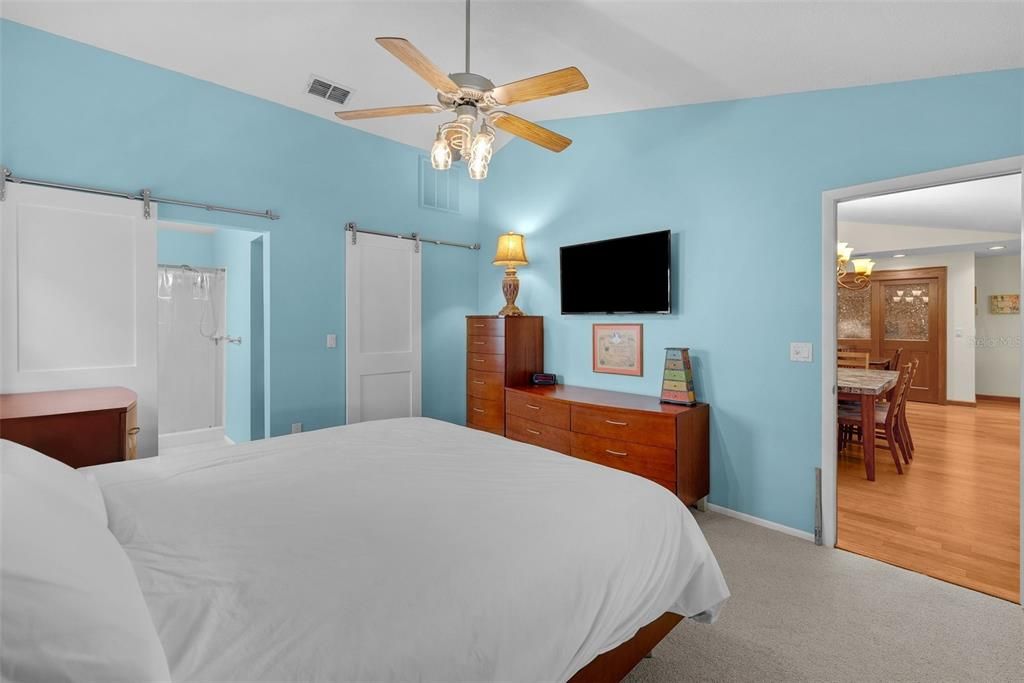 Master bedroom with barn doors to the walk-in closet and bathroom