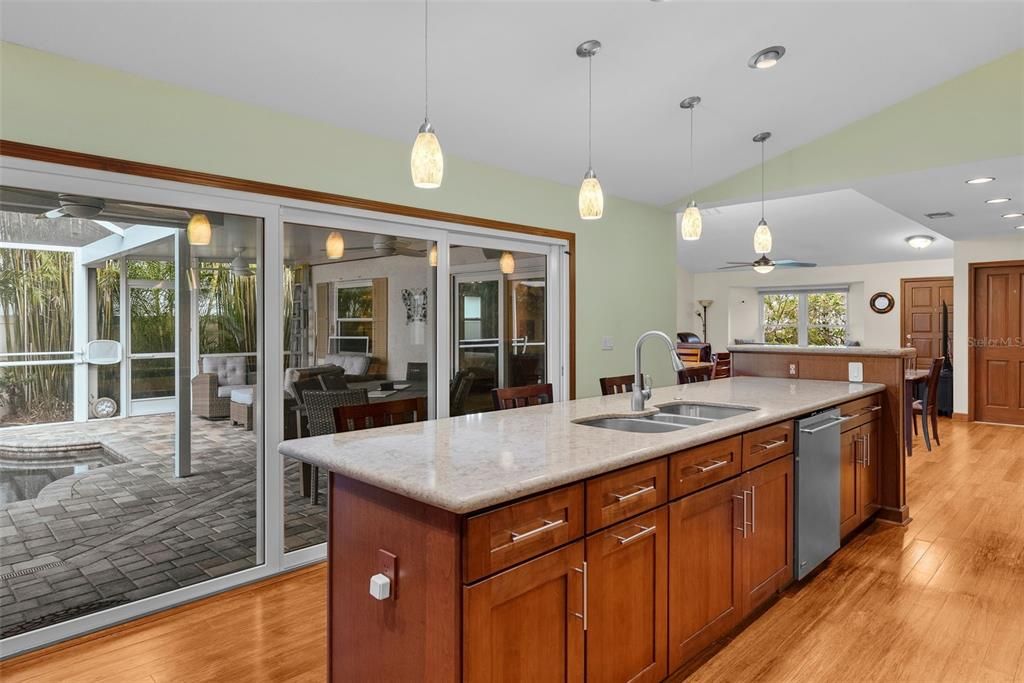 This is a view of the pool and patio from the kitchen. The view is unobstructed, and the kitchen is well-lit.