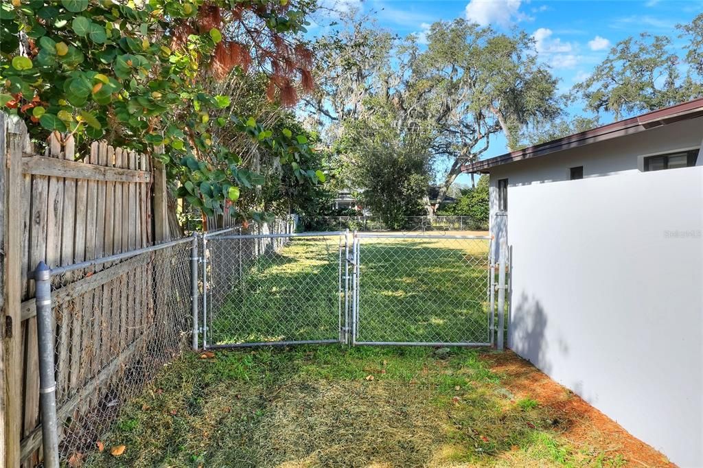 Convenient and usefful ouble-gated entry into the back yard outside primary bedroom courtyard. Park your toys!